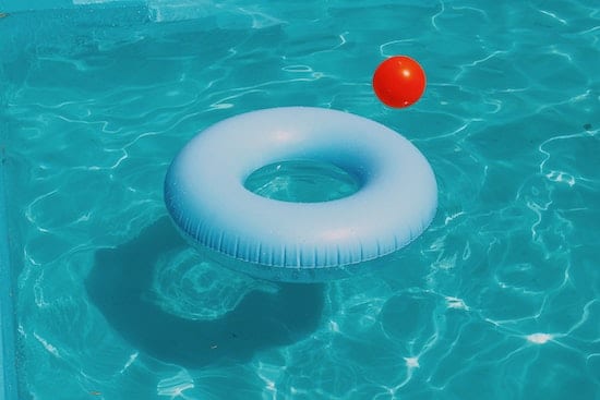two inflatables in a pool heated by one of the top in-ground solar pool heaters of 2020