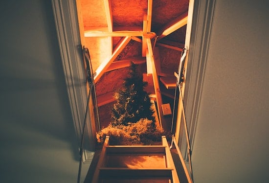 Picture of an attic with a christmas tree. 