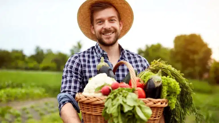 man with fresh garden vegetables